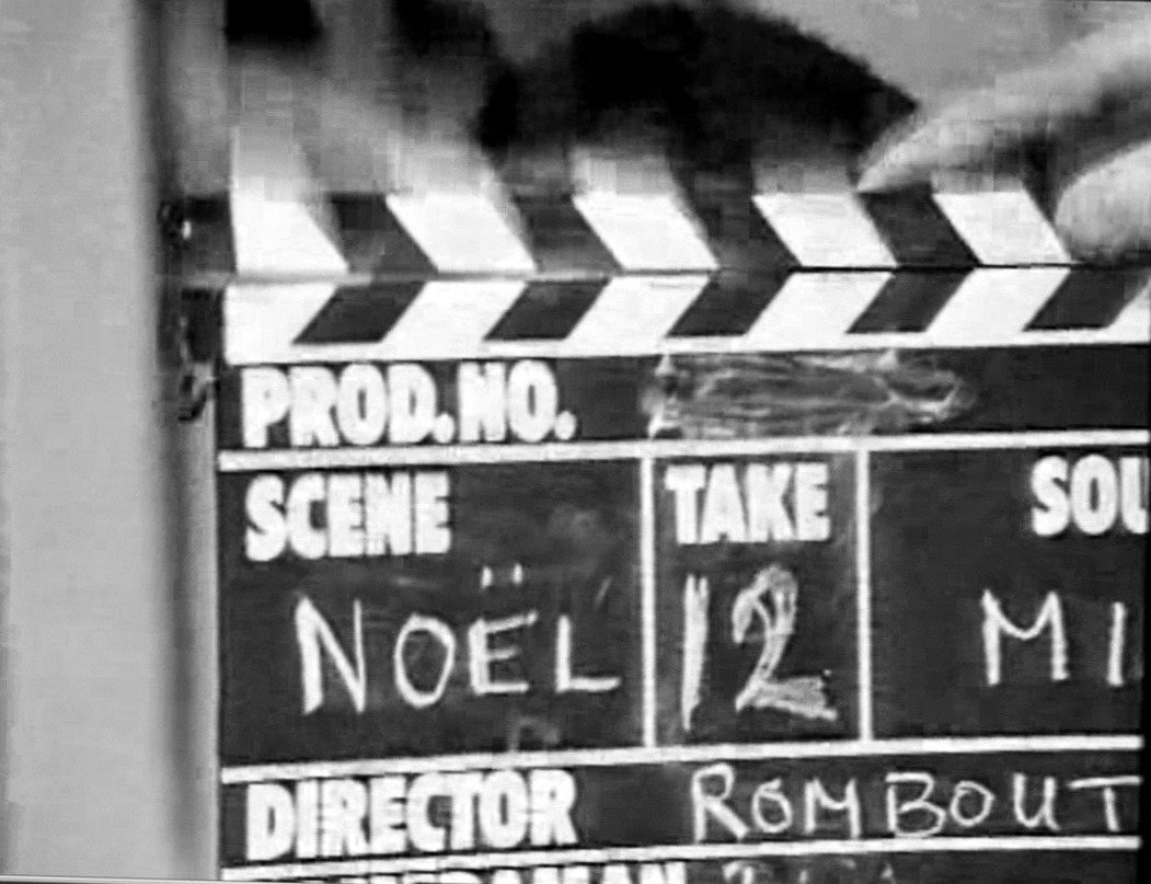 A clapperboard reading Noël, take 12, director Rombout