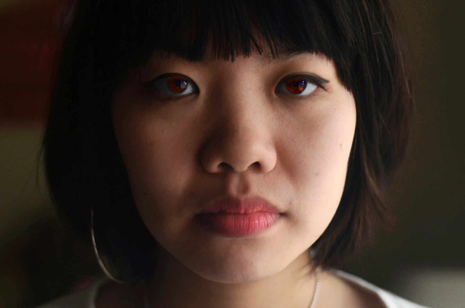 A young woman with a fringe looking into the lens